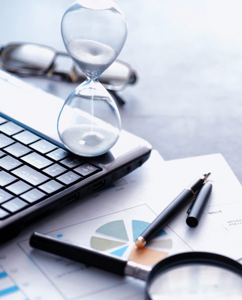 Working time symbolizes an hourglass. Office desk with insurance manager and banker. Office employee at the table. The concept of lack of time.